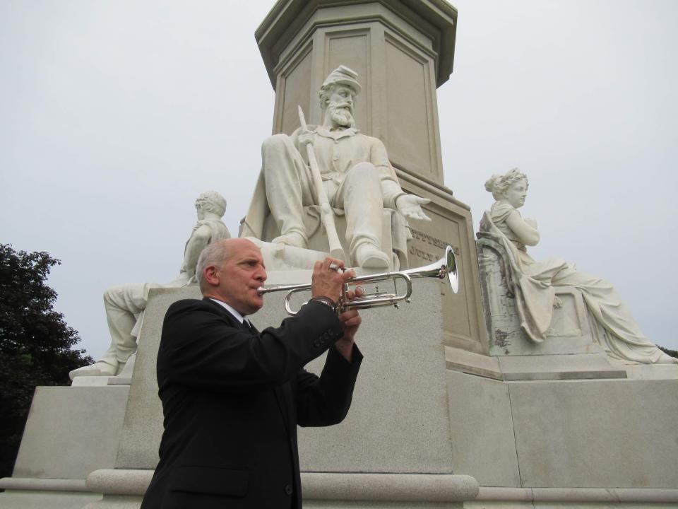 David Bufalini of Hopewell plays "Taps" at the Gettysburg Memorial Cemetery.