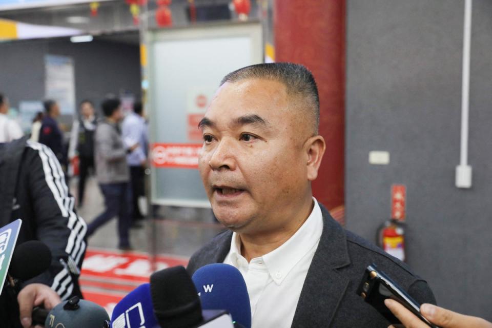 China’s Red Cross staff Li Chaohui speaking to the press upon his arrival in Kinmen as relatives of two fisherman arrive (CNA/AFP via Getty Images)