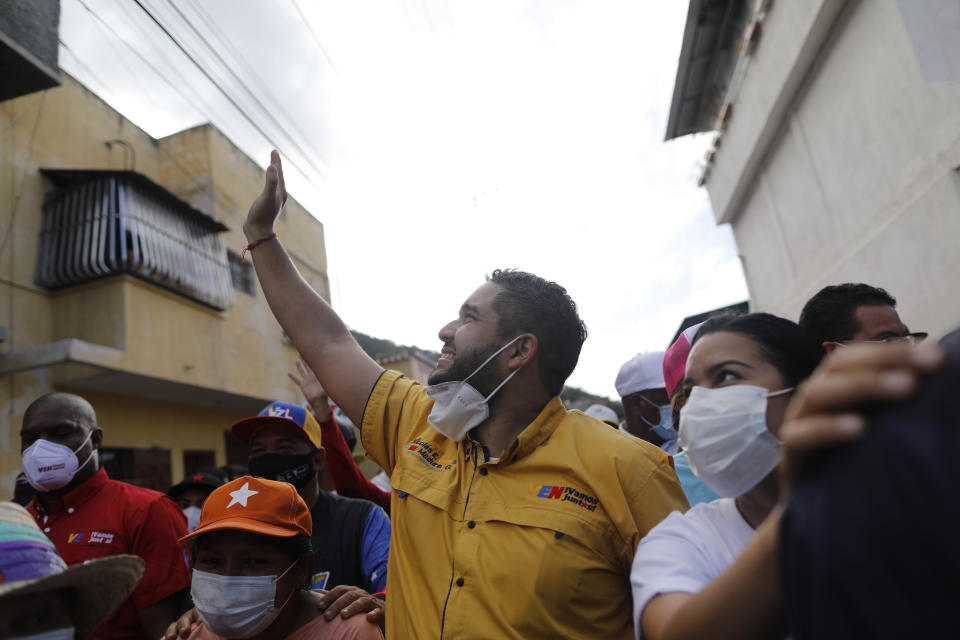 Nicolas Maduro Guerra, son of Venezuela's President Nicolas Maduro, campaigns for a spot in the National Assembly for the upcoming Dec. 6 midterm elections, in Maiquetía, Venezuela, Sunday, Nov. 29, 2020. (AP Photo/Ariana Cubillos)