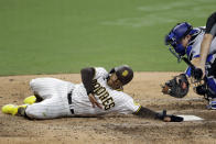 San Diego Padres' Trent Grisham, left, slides past home after being tagged out by Los Angeles Dodgers catcher Will Smith, ending the baseball game Wednesday, Aug. 5, 2020, in San Diego. (AP Photo/Gregory Bull)