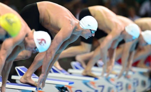 Ryan Lochte (2nd L) and fellow competitors at the starting block for Heat 13 of the men's 200m Individual Medley on day five of the 2012 US Olympic Team Trials, on June 29, in Omaha, Nebraska. Lochte came out on top in another semi-final tussle with Michael Phelps as he set himself up for a tilt at a 200m backstroke-medley double