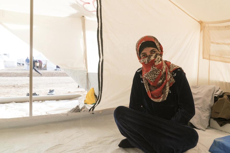 Su'ad Brahim sits for a portrait in her tent in the Hasemsham Camp outside Mosul, Iraq in this Nov. 9, 2016 photo. Brahim supported her family in Mosul by baking and selling bread during the Islamic State group’s rule over the city. Many in Mosul scrounged to make a living, selling off what they could to get by as the militants reduced the once thriving, multicultural city to a place of darkness, fear and poverty, fleeing residents say. (AP Photo/Nish Nalbandian)