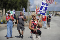 Mara Paulic, a 42-year GM employee, pickets outside the General Motors Fabrication Division, Monday, Sept. 23, 2019, in Parma, Ohio. The strike against General Motors by 49,000 United Auto Workers entered its second week Monday with progress reported in negotiations but no clear end in sight. (AP Photo/Tony Dejak)