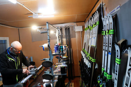 Heinz Haemmerle, or "Magic Heinzi" as US skier Lindsey Vonn calls her Austrian-born ski technician, sharpens the edges on a pair of skis of the world's most successful skiing women in his tiny waxing container at the Winter Olympics 2018 in Pyeongchang, South Korea February 19, 2018. Picture taken February 19, 2018. REUTERS/Leonhard Foeger