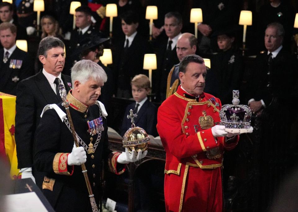 The Imperal State Crown, Orb and Sceptre are carried to the Dean of Windsor (not seen) to be placed on the high altar (Victoria Jones/PA) (PA Wire)