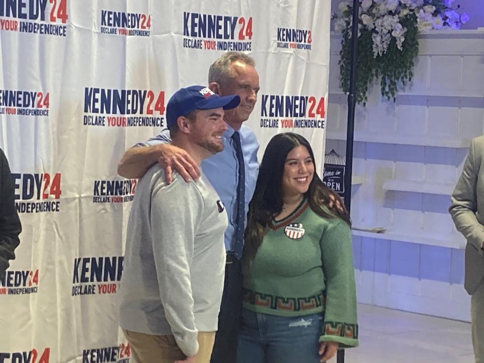 Scottsdale residents Heath and Christina McLaughlin pose for a photo with independent presidential candidate Robert Kennedy Jr. on Wednesday, Dec. 20, 2023 in Phoenix.