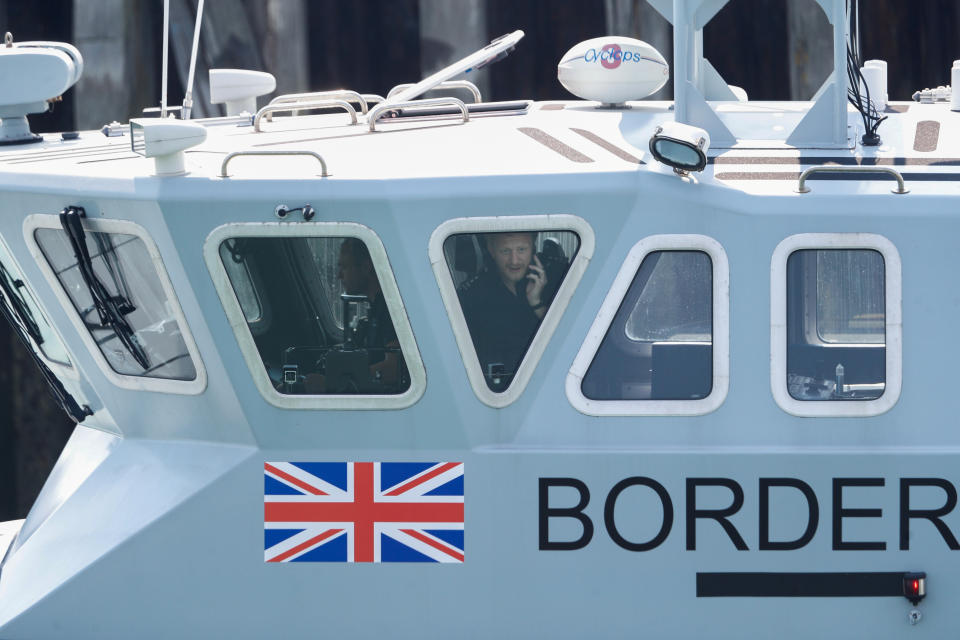 An officer looks out of a window at Dover harbour from a Border Force boat, in Dover, Britain August 11, 2020. REUTERS/Peter Nicholls