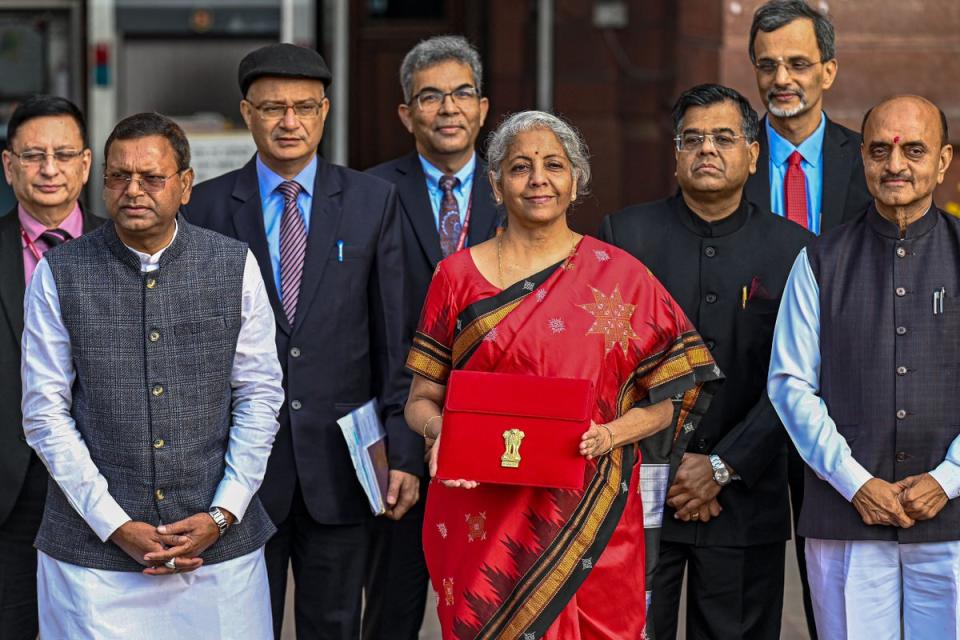 India’s finance minister Nirmala Sitharaman (centre) poses for a photograph as she leaves the finance ministry to present the annual budget in the parliament in New Delhi (AFP via Getty Images)