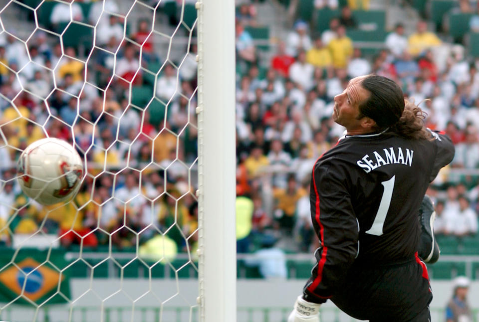 England's David Seaman can only watch as he is beaten by Brazil's Ronaldinho for their winning goal from a free-kick.