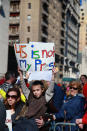 <p>A youngster with his mother holds up a sign during the “Not My President’s Day” rally at Central Park West in New York City on Feb. 20, 2017. (Gordon Donovan/Yahoo News) </p>