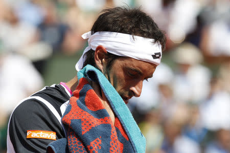 FILE PHOTO: Potito Starace of Italy wipes his face during his match against Novak Djokovic of Serbia during the French Open tennis tournament at the Roland Garros stadium in Paris May 28, 2012. REUTERS/Regis Duvignau/File Photo