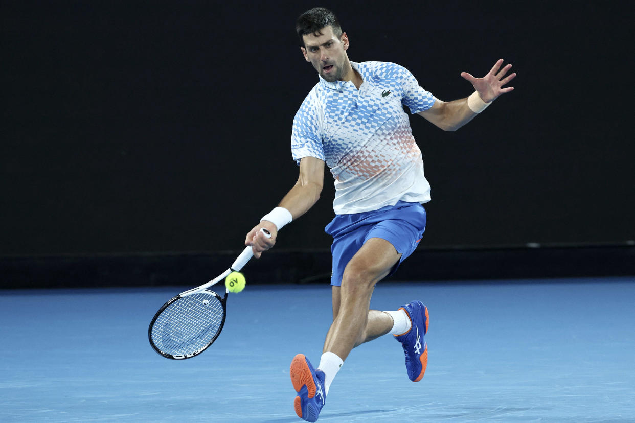 Serbia's Novak Djokovic hits a return against Greece's Stefanos Tsitsipas during their men's singles final match on day fourteen of the Australian Open tennis tournament in Melbourne on January 29, 2023. (Photo by DAVID GRAY / AFP) / -- IMAGE RESTRICTED TO EDITORIAL USE - STRICTLY NO COMMERCIAL USE --