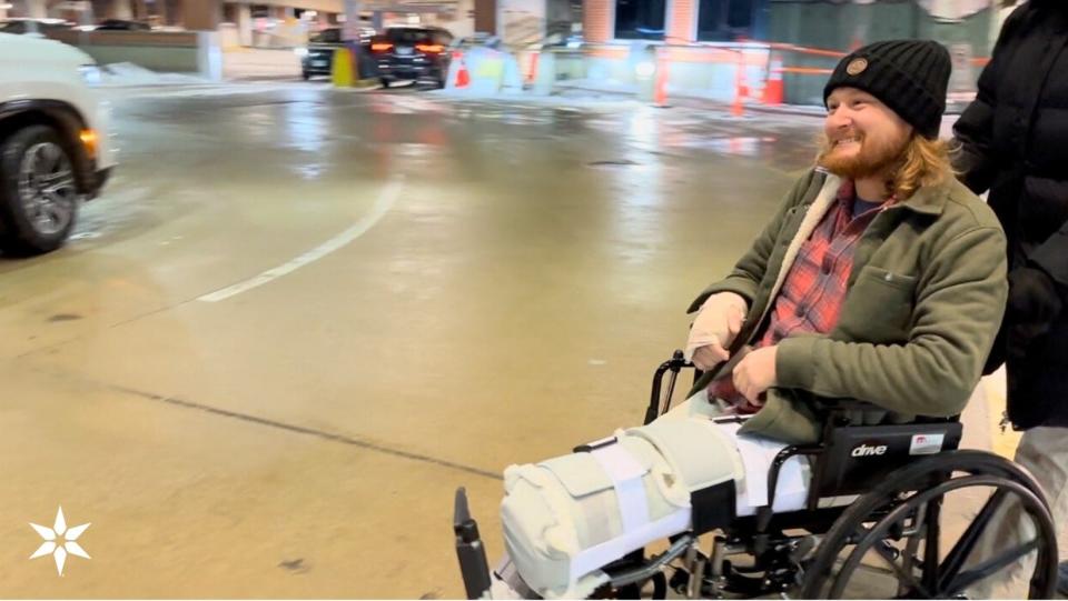 A smiling Matt Reum is photographed as he leaves Memorial Hospital in South Bend on Tuesday evening, about a month after a Dec. 20 crash trapped him in his pickup truck for six days.