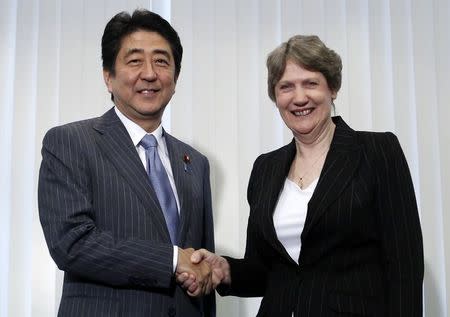 United Nations Development Programme (UNDP) Administrator Helen Clark (R) shakes hands with Japan's Prime Minister Shinzo Abe at the start of their meeting, ahead of the Global Launch of Human Development Report 2014 at the United Nations University Headquarters in Tokyo July 24, 2014. REUTERS/Yuya Shino