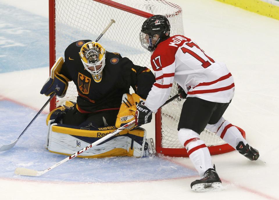 Canada's Connor McDavid scores on Germany's goalie Marvin Cupper during the third period of their IIHF World Junior Championship ice hockey game in Malmo, Sweden, December 26, 2013. REUTERS/Alexander Demianchuk (SWEDEN - Tags: SPORT ICE HOCKEY)