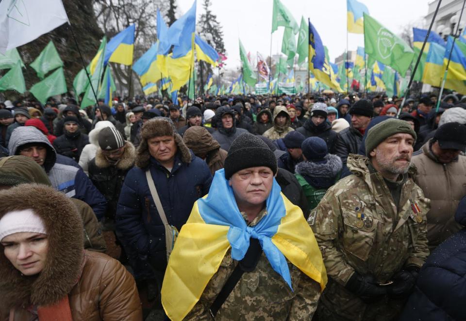 People take part in a rally outside the Ukrainian parliament in Kiev, Ukraine, Tuesday, Feb. 21, 2017. Protesters were demanding a stop to trade relations with Russia-occupied Ukrainian territories. (AP Photo/Sergei Chuzavkov)