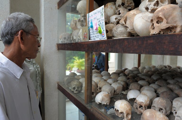 A Cambodian looks at skulls displayed at the Tuol Sleng genocide museum in Phnom Penh on August 31, 2009. Led by Pol Pot, who died in 1998, the Khmer Rouge wiped out up to two million people -- nearly a quarter of the population -- through starvation, overwork or execution in a bid to create an agrarian utopia