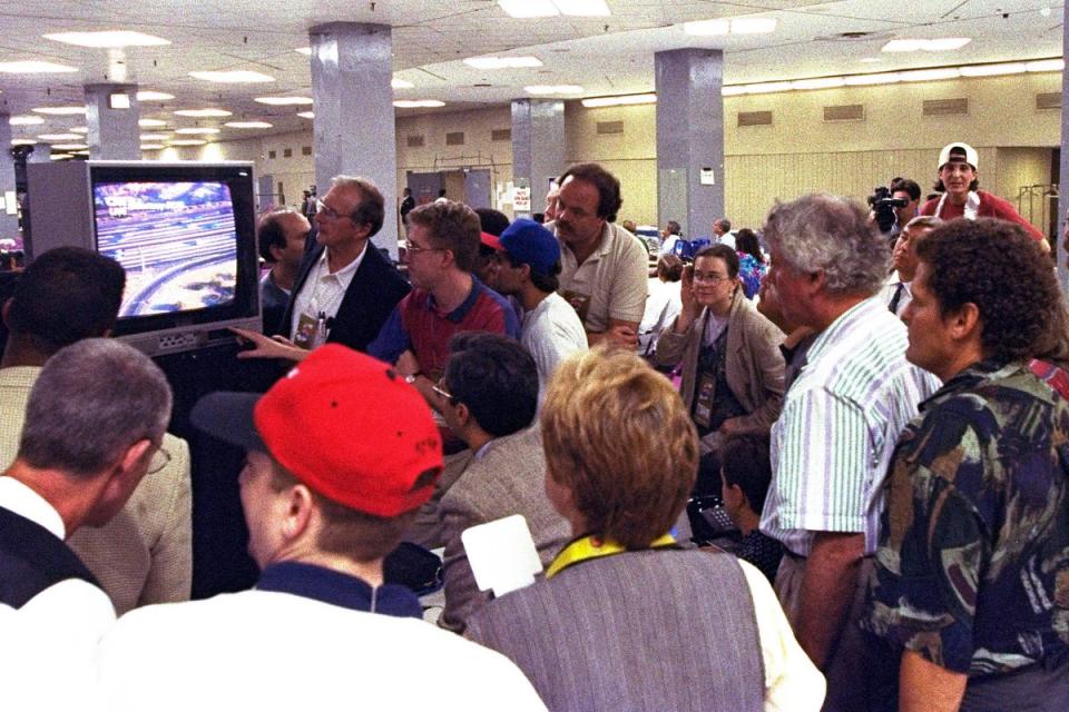 Members of the news media watch live television coverage of the O.J. Simpson slow speed chase on Los Angeles freeways during Game 5 of the NBA finals in New York City (AP)