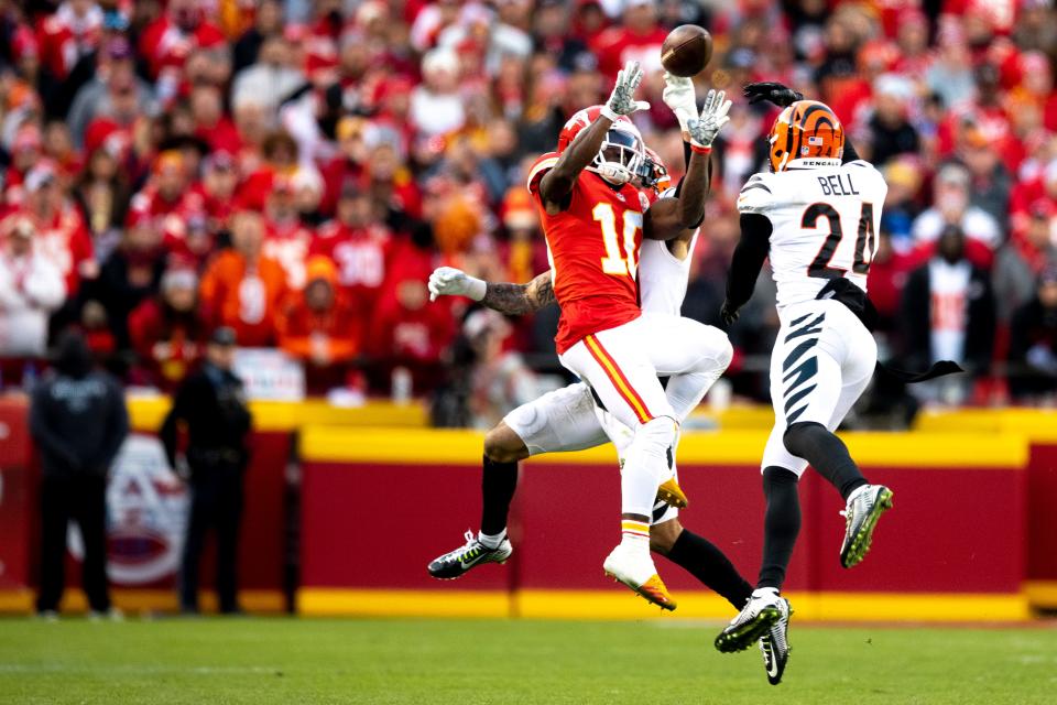 Bengals free safety Jessie Bates, rear, knocks the ball away from Chiefs wide receiver Tyreek Hill so Bengals safety Vonn Bell can intercept it in overtime of the AFC Championship Game.