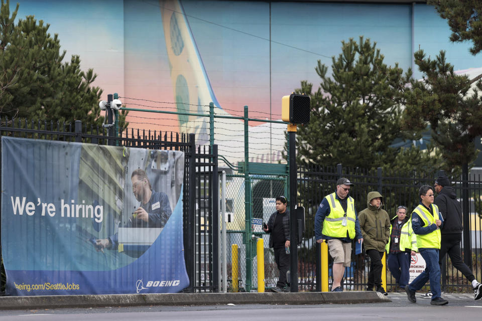 Boeing workers are pictured outside a pedestrian gate as Boeing's 737 factory teams hold the first day of a 