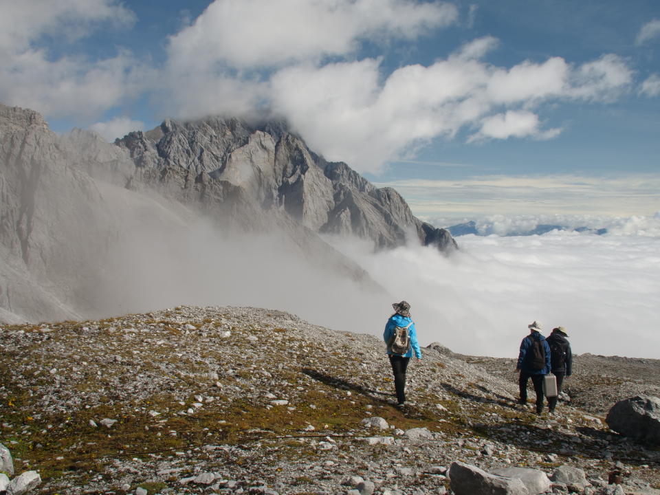 This Sept. 21, 2018 photo shows a Chinese Academy of Sciences research team atop the Jade Dragon Snow Mountain in the southern province of Yunnan in China. They are part of ongoing efforts to track the melting of the mountain's Baishui Glacier No.1 which has lost 60 percent of its mass and shrunk 250 meters since 1982. (AP Photo/Sam McNeil)