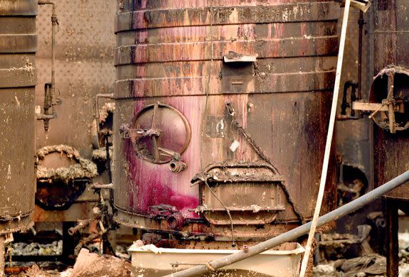 Charred fermentation tanks drip wine at a destroyed Paradise Ridge Winery in Santa Rosa.