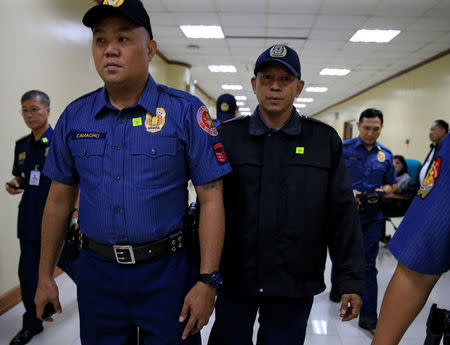 Philippines National Police (PNP) officer Arnel Oares is escorted as he appears during a hearing on the killing of 17-year-old high school student Kian Delos Santos in a recent police raid, at the Senate headquarters in Pasay city, metro Manila, Philippines August 24, 2017. REUTERS/Romeo Ranoco