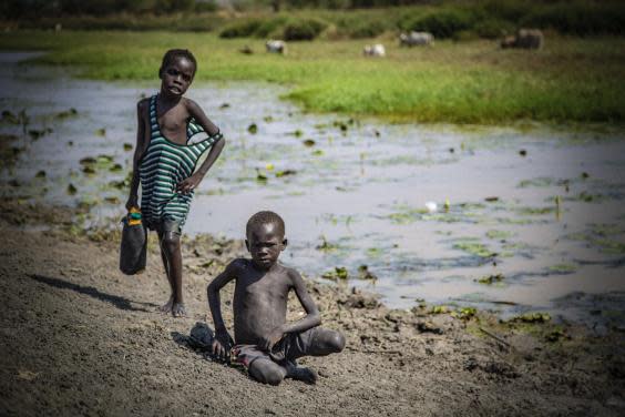 Boys on the banks of a seasonal river that is drying out a month too early due to climate change in South Sudan (Bel Trew)