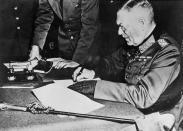 <p>Wilhelm Keitel, Chief of Defense for Germany, signs the surrender terms for the German Army in Berlin. Keitel was tried in the Allied court at Nuremberg, sentenced to death, and hanged as a war criminal. His reported last words: "I call on God Almighty to have mercy on the German people. More than two million German soldiers went to their death for the fatherland before me. I follow now my sons—all for Germany."</p>