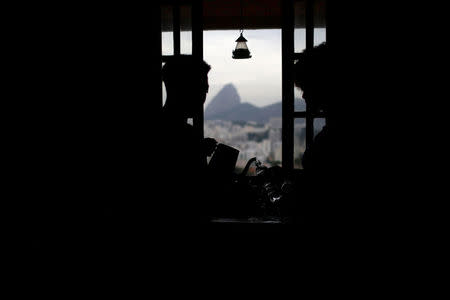 A worker serves coffee to a guest at Pousada Favelinha (Little favela) hostel kitchen in Pereira da Silva favela, in Rio de Janeiro, Brazil, April 29, 2016. REUTERS/Pilar Olivares