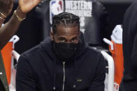 FILE - Los Angeles Clippers forward Kawhi Leonard sits on the bench during the first half in Game 6 of the NBA basketball Western Conference Finals against the Phoenix Suns in Los Angeles, in this Wednesday, June 30, 2021, file photo. The biggest question hanging over the Clippers is when Leonard will return. Will he work his way back from knee surgery to repair a partially torn ACL before the end of the regular season? Or for the playoffs? Or remain out until next season? Even he isn't sure. (AP Photo/Mark J. Terrill, File)