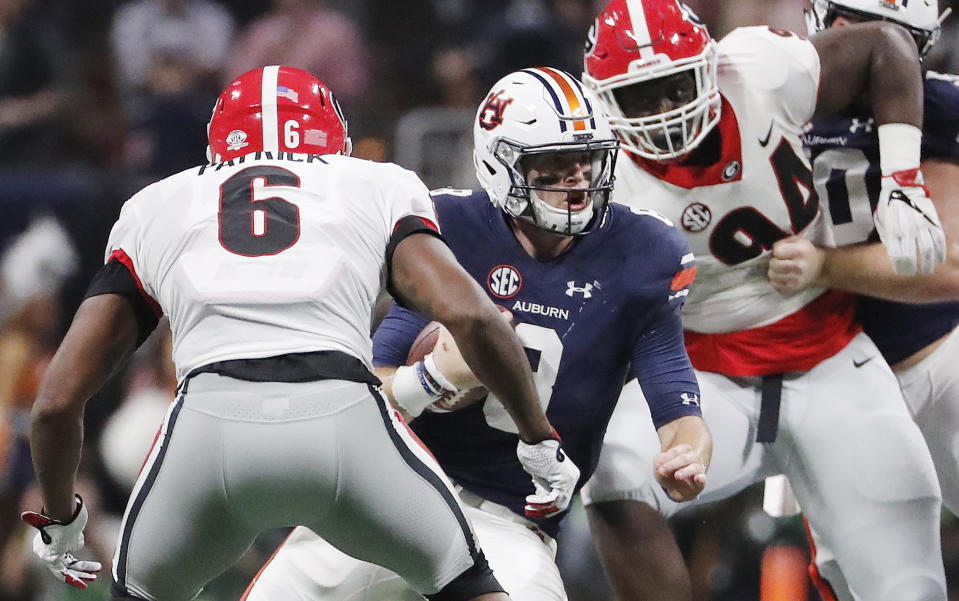 Auburn quarterback Jarrett Stidham (8) runs as Georgia linebacker Natrez Patrick (6) during the first half of the Southeastern Conference championship NCAA college football game, Saturday, Dec. 2, 2017, in Atlanta. (AP Photo/David Goldman)