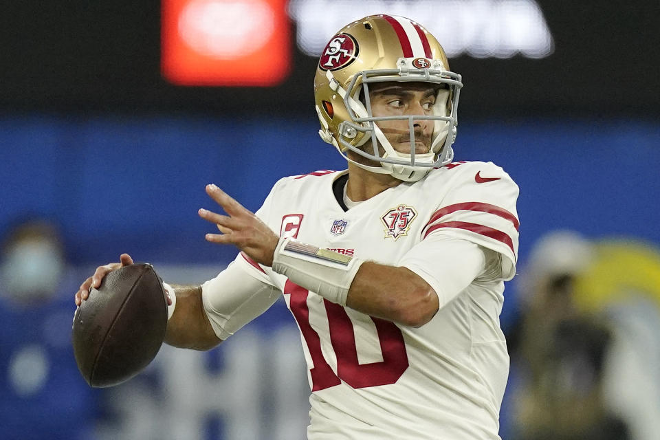 FILE - San Francisco 49ers' Jimmy Garoppolo looks to throw during the second half of the NFC Championship NFL football game against the Los Angeles Rams, Jan. 30, 2022, in Inglewood, Calif. Garoppolo expects his shoulder to be ready for training camp — wherever that may be. He told the AP Pro Football Podcast on Thursday, April 21, 2022, that his rehab is going well and it is helping him deal with uncertainty surrounding his future with the 49ers. (AP Photo/Mark J. Terrill, File)