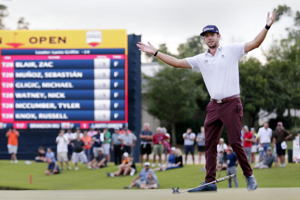 Lanto Griffin drops his putter and throws his arms up after sinking his final putt to win the Houston Open golf tournament Sunday, Oct, 13, 2019, in Houston. (AP Photo/Michael Wyke)