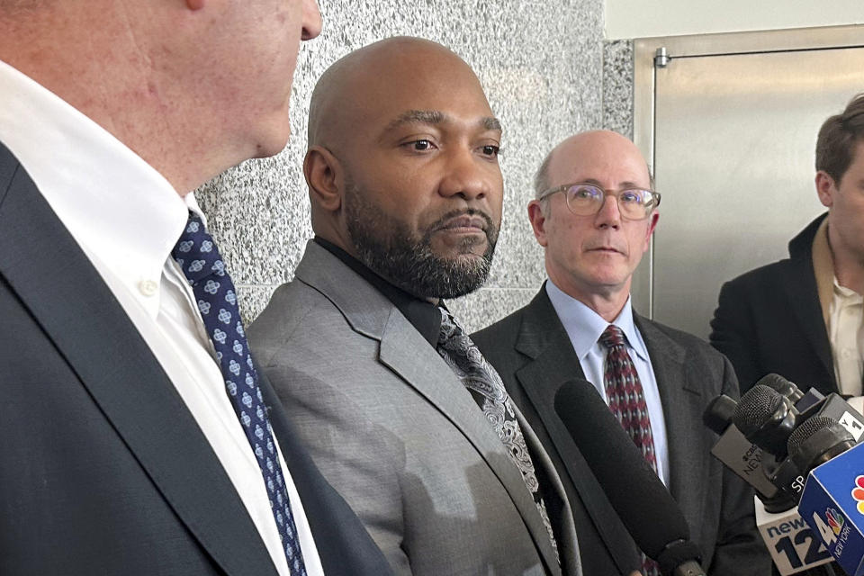 Steven Ruffin, center, who served 14 years in prison for a deadly 1990s shooting, speaks to the media, in the Brooklyn borough of New York, after he was was exonerated, Thursday, Jan. 18, 2024. Prosecutors said they now believe the killer was an acquaintance Ruffin has implicated for decades. (AP Photo/Jennifer Peltz)