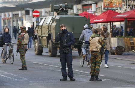 Belgian soldiers and police patrol in central Brussels as police searched the area during a continued high level of security following the recent deadly Paris attacks, Belgium, November 23, 2015. REUTERS/Yves Herman