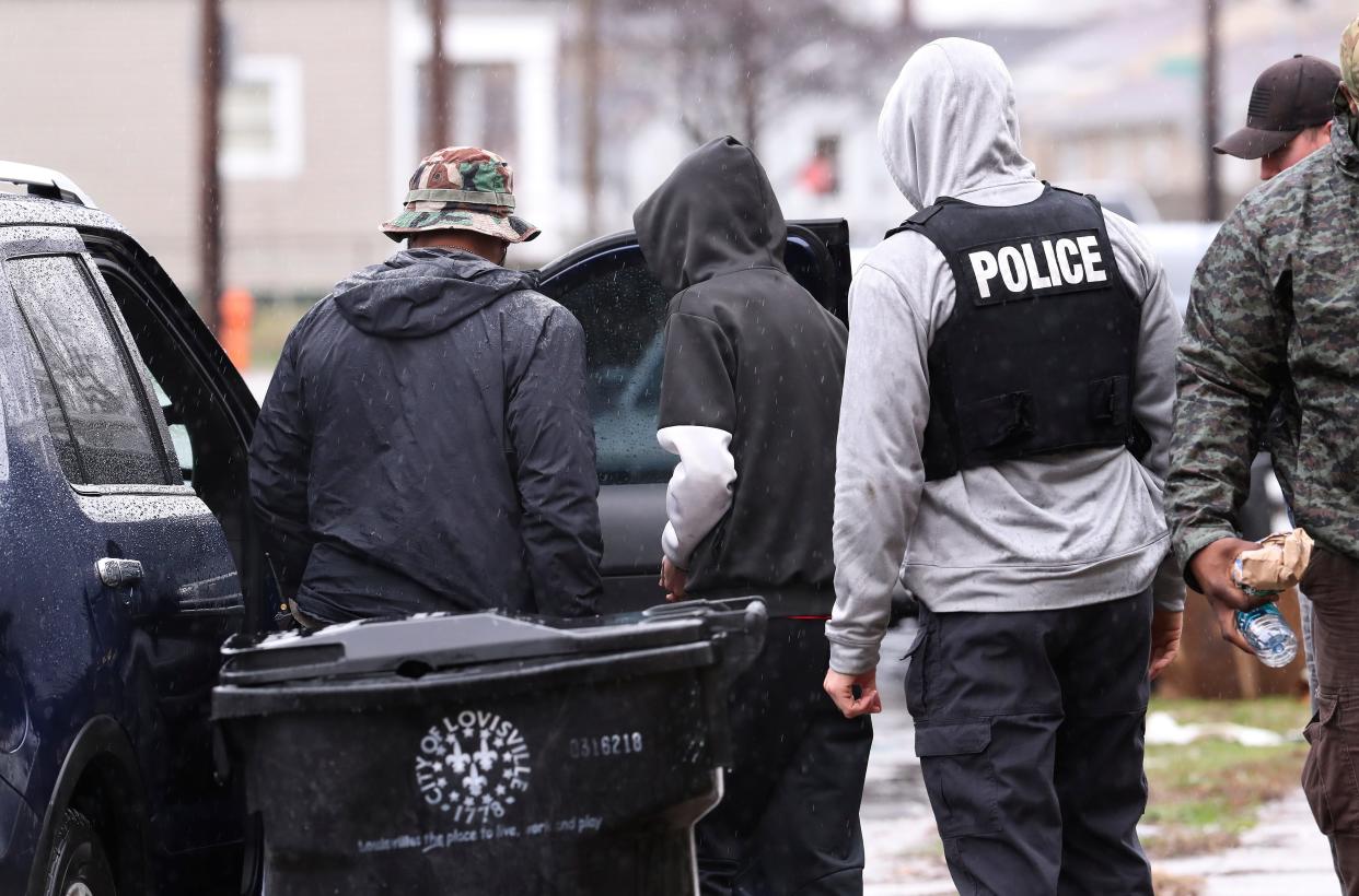 Ninth Mobile officers apprehend a suspect, center, after surveilling a home on Jan. 23, 2019.