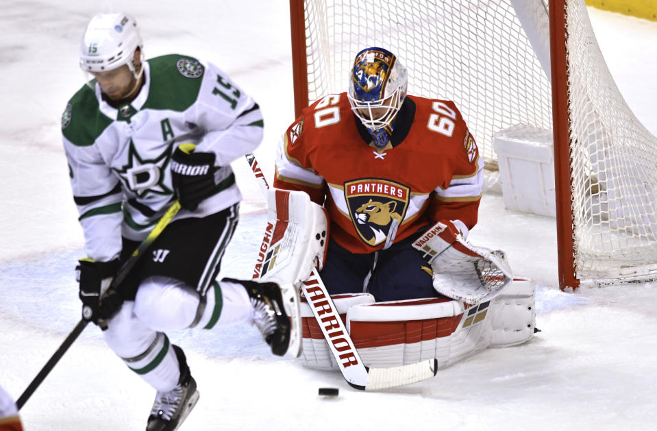 Florida Panthers goaltender Chris Driedger (60) makes a save behind a screen by Dallas Stars' Blake Comeau (15) during the first period of an NHL hockey game Wednesday, Feb. 24, 2021, in Sunrise, Fla. (AP Photo/Jim Rassol)