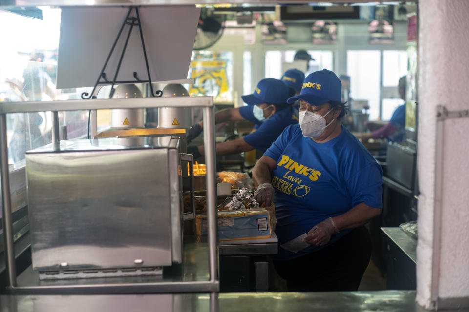 Los Angeles, CA - February 03: Pink&#39;s Hot Dogs employees wear blue and gold shirts recognizing the Rams Thursday, Feb 3, 2022 at eatery in Los Angeles. The restaurant is selling L.A.Rams Blue and Gold hot dogs in celebration of the Rams making it to the Super Bowl. The all-beef 9-inch Hot Dog features mustard, onions, Pink&#39;s famous chili, nacho cheese, and three strips of bacon. The frankfurter is $6.50, with all proceeds from the sales donated to the LA Rams Foundation to support at-risk youth in Los Angeles. (Photo by Hans Gutknecht/MediaNews Group/Los Angeles Daily News via Getty Images)(Photo by Hans Gutknecht/MediaNews Group/Los Angeles Daily News via Getty Images)