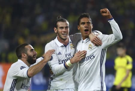 Football Soccer - Borussia Dortmund v Real Madrid - UEFA Champions League group stage - Group F - Signal Iduna Park stadium, Dortmund, Germany - 27/09/16 - Real Madrid's Raphael Varane reacts with Gareth Bale and Dani Carvajal REUTERS/Kai Pfaffenbach