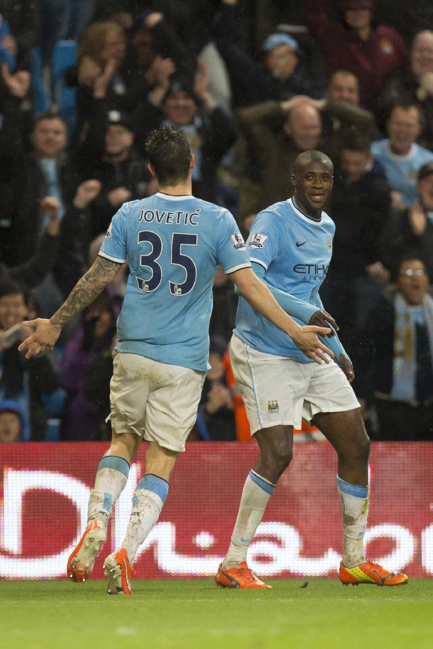 Manchester City's Yaya Toure, right, celebrates with teammate Stevan Jovetic after scoring against Aston Villa during their English Premier League soccer match at the Etihad Stadium, Manchester, England, Wednesday May 7, 2014. (AP Photo/Jon Super)