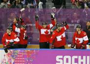 Canada's bench celebrates during their men's semi-final ice hockey victory over Team USA at the 2014 Sochi Winter Olympic Games, February 21, 2014. REUTERS/Gary Hershorn