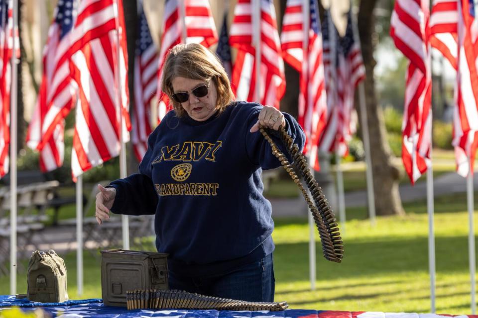 Jill Hernandez sets up the Veterans Day display at Plaza Park.