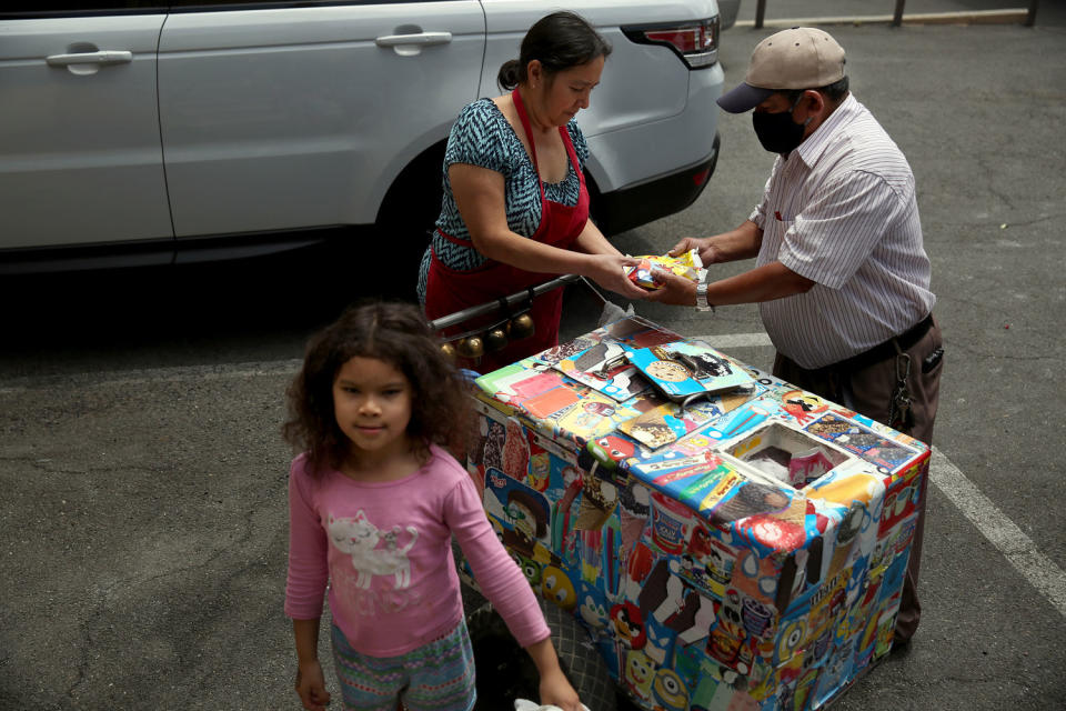IMage: Mauro Rios Parra sells paletas in Pic Union, near Los Angeles, in 2020. Parra came to the United States from Mexico 20 years ago, and has sold paletas to support his family. (Dania Maxwell / Los Angeles Times via Getty Images file)