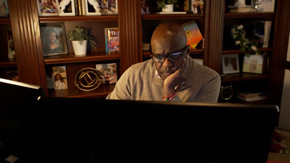 Bob Otondi, a Texas business owner whose mortgage application was denied by Navy Federal, working at home. - CNN