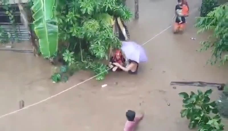 Rescuers help people affected by floods, in Gingoog city