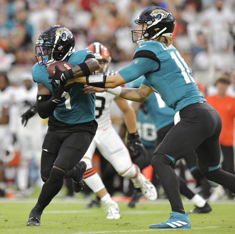 Jacksonville Jaguars quarterback Trevor Lawrence (16) hands off to running back Travis Etienne Jr. (1) during first quarter action. The Jaguars hosted the Cleveland Browns at TIAA Bank Field in Jacksonville on Friday, Aug. 12, 2022 for the first home preseason game of the season.