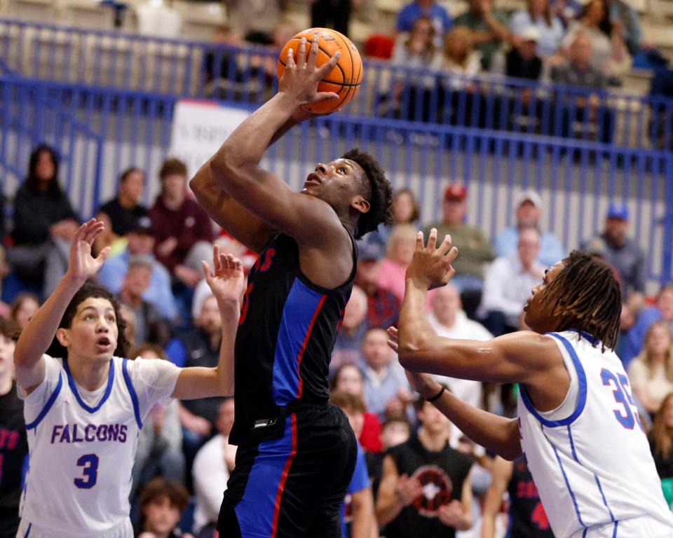 Luke Gray, center, of OCS prepares to shoot between Millwood's Amari Barrett (3) and Braelon Bradshaw (35) during a boys high school basketball game between Oklahoma Christian School and Millwood at the Millwood Field house in Oklahoma City, Tuesday, Feb. 6, 2024.