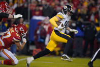 Pittsburgh Steelers outside linebacker T.J. Watt (90) runs from Kansas City Chiefs tight end Travis Kelce (87) while returning a fumble for a touchdown during the first half of an NFL wild-card playoff football game, Sunday, Jan. 16, 2022, in Kansas City, Mo. (AP Photo/Ed Zurga)