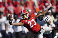 Georgia wide receiver Jaylen Johnson (23) can't hang on to a pass as Charleston Southern defensive back Jarrod Stanley (12) defends in the first half of an NCAA college football game Saturday, Nov. 20, 2021, in Athens, Ga. (AP Photo/John Bazemore)